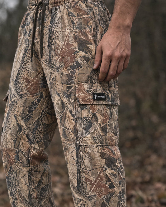 Crossway camo cargo sweatpants, close detail of the thigh cargo pocket and woven label